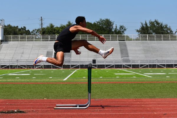 A Student running the track at St. Pete Highschool's football field